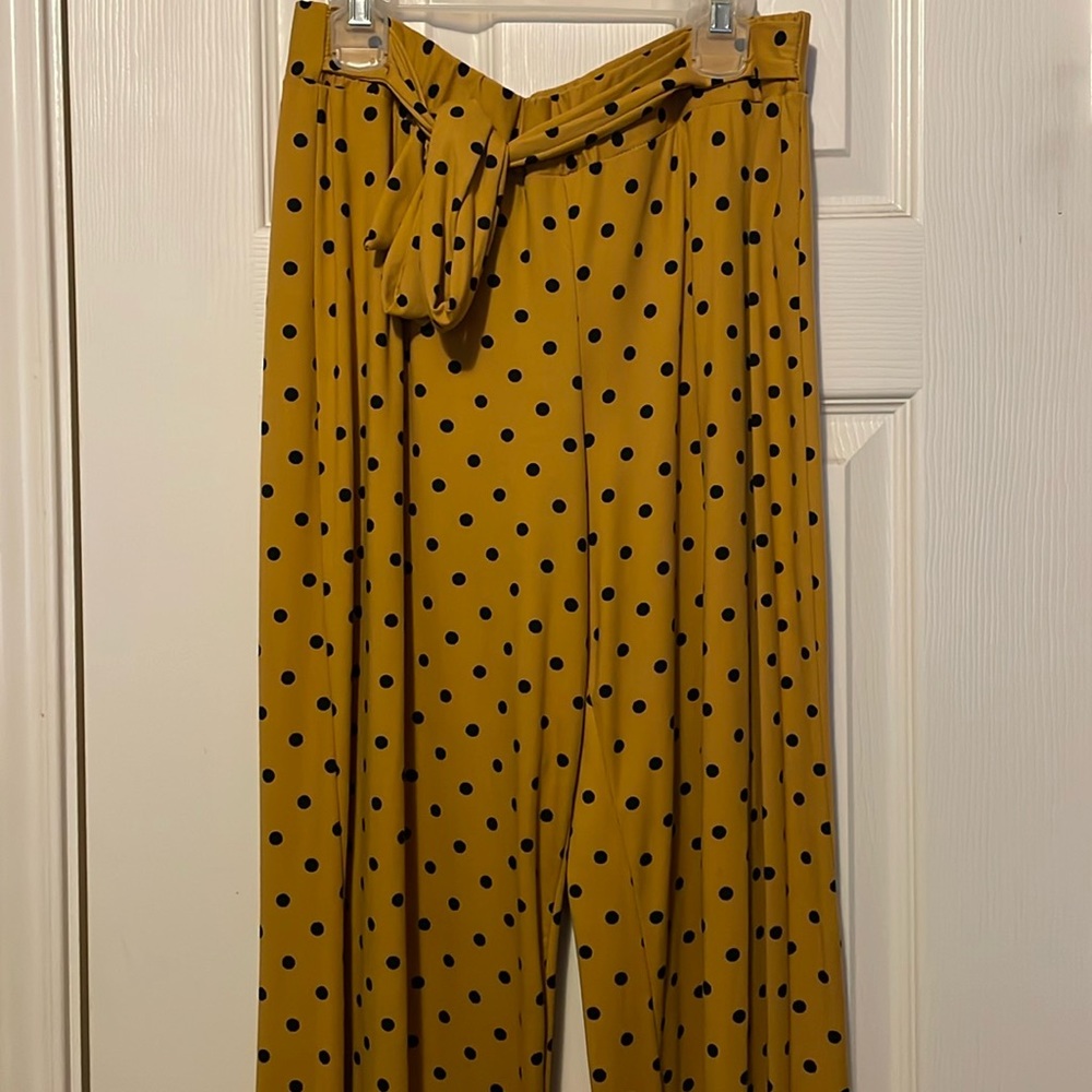 Yellow pants with black polka dots